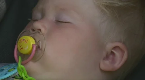Kid is sleeping and sucking a pacifier Stock-Footage 64648951