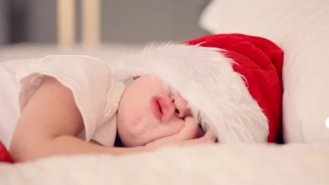 Kid sleeping with santa hat and waiting Santa's gift. Peaceful child Stock Footage 70555115