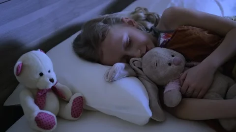Kid sleeps in bed at night Stock Footage