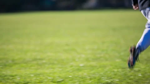 Kid on soccer field running around and kicking ball Stock Footage 45973575