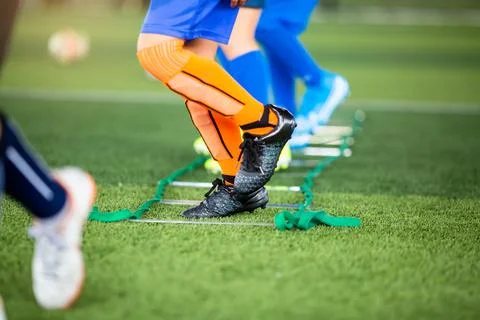 Kid soccer player Jogging between marker for football training. Stock Photos