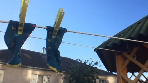 Kid socks outside. Drying wet clothes Stock Footage 93002492