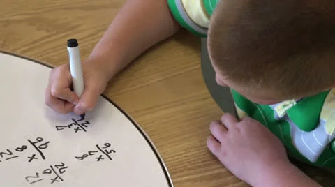 Kid solving math problems Stock Footage 26585222
