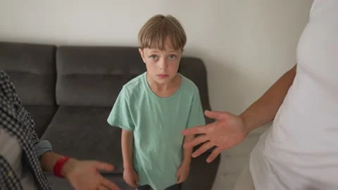 Kid son feels upset while parents fighting at background, sad little girl Stock Footage 195122573