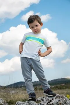 Kid standing on the rock Stock Photos