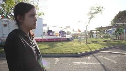 Kid stands in front of empty carnival Stock Footage 154570053