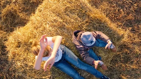 The kid stands on the haystack and waves his hands. He plays and laughs Vídeos de archivo 118140502