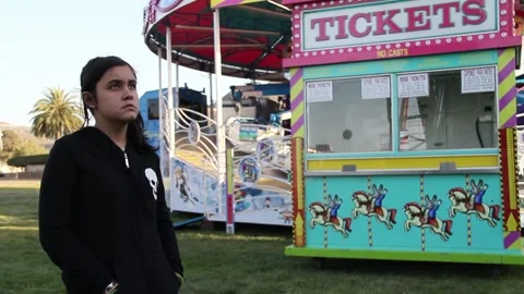 Kid stands by ticket booth at empty carnival Stock Footage 154939123