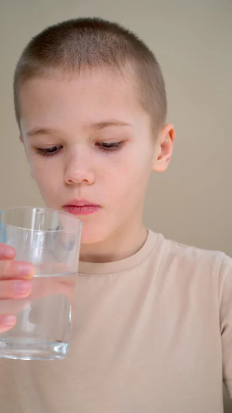 Kid staying hydrated with glass of water Stock Footage 329024924