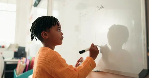 Kid, student and writing on whiteboard in class for lesson, answer to question Stock Footage 316144092
