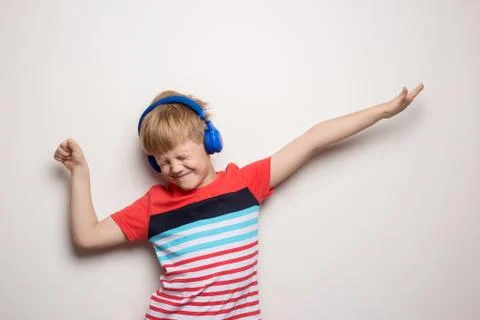 Kid Studio Shoot Using Headphone Listening Music. Isolated on white Stock Photos