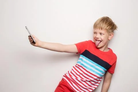 Kid Studio Shoot Using Headphone Listening Music. Isolated on white Foto stock