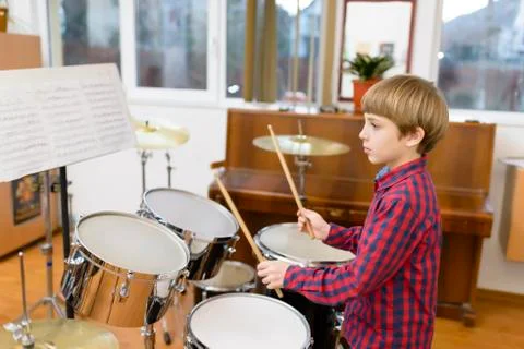 Kid studying drums at school Stock Photos