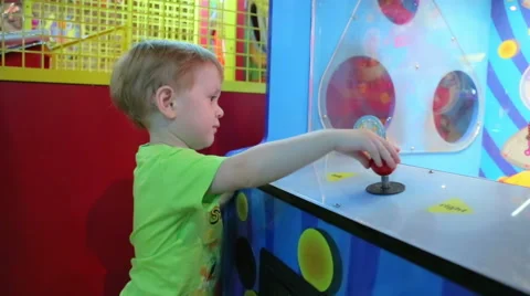 The kid is studying the gaming machine Stock Footage 44716837