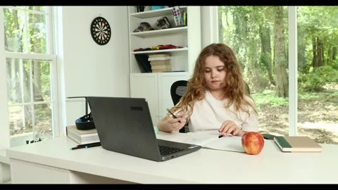 Kid studying mathematics on laptop during e-learning session. Student streaming Stockbeeldmateriaal 318693373