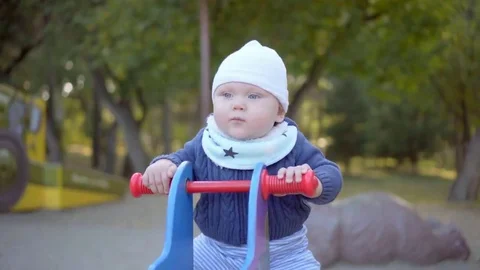 Kid swinging and jumping on a swing in the park Stock Footage 69088816
