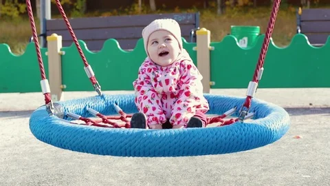 The kid is swinging on the swing Stock Footage 95585921