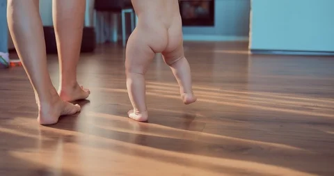 Kid takes the first steps with his mother. Baby's naked body Stock-Footage 95300321