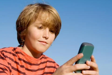 Kid texting with cell or mobile phone Stock Photos