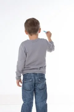 Kid thinking with chalk in hand Stock-Fotos
