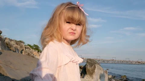 Kid throwing rocks across water at sea beach. Child skipping stones on lake Stock Footage 295958270