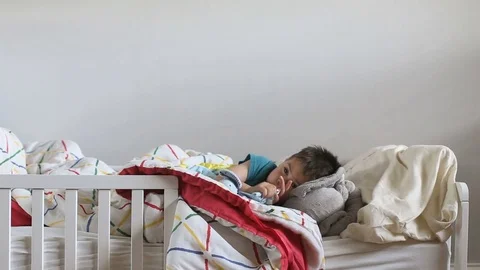 Kid tired and in bed, video Stock Footage 79659401
