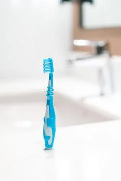Kid toothbrush in the bathroom Stock Photos