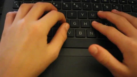 A kid touching the keys of laptop Stock Footage 324681617