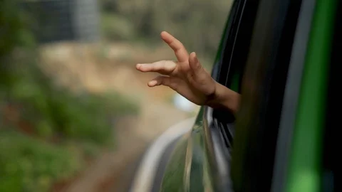 Kid travel by the car. Child putting his hand out of the car window. Stock Footage
