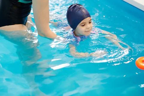Kid try catch toy in pool Stock Photos