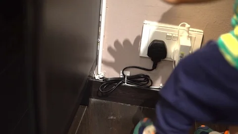 A kid turning off a wall switch. Safety and hazard concept Stock Footage 98600390