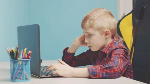 The kid typing on his laptop Stock Footage 150185753