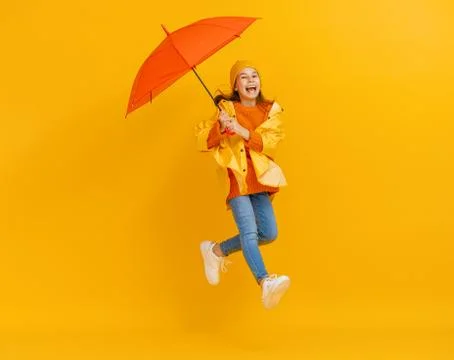 Kid with umbrella on colored background. Stock Photos