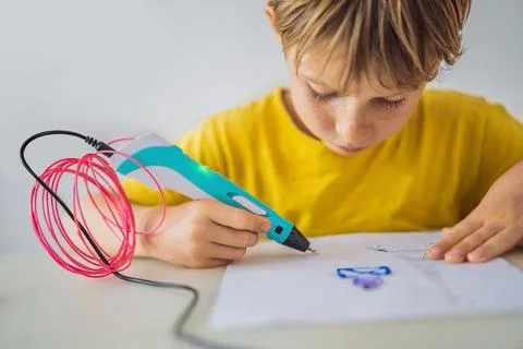 Kid using 3d printing drawing pen. Creative, leisure, technology education 写真素材