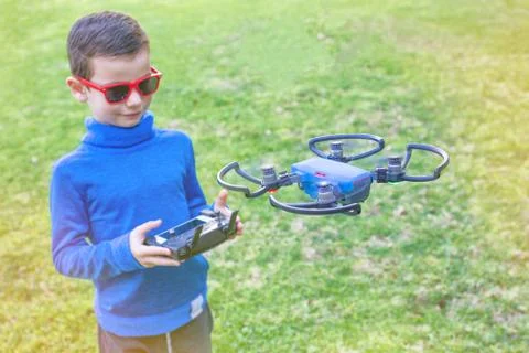 A kid using a drone controller to navigate a drone Stock Photos