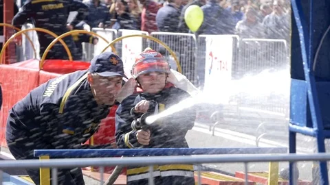Kid using fire hose at firefighter festival in Kyiv Stockbeeldmateriaal 116381433