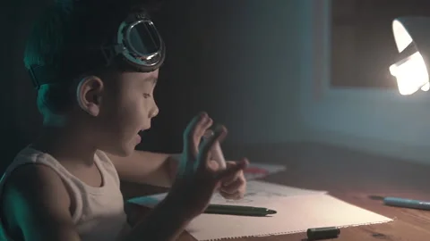 Kid using his imagination to draw and paint on a paper sheet at home. Stock Footage 222882677