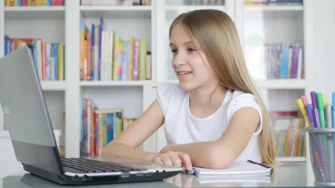 Kid Using Laptop Studying in Video Conferencing, Child Learning, Writing Stock Footage 131146317