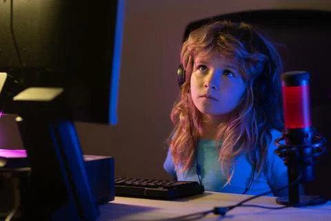 Kid using pc at night. Child with computer in a dark room. Social network for 写真素材