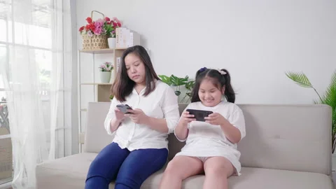 Kid using phone too much and ignoring mother. Mom upset and Mom angry Stock Footage 163853993