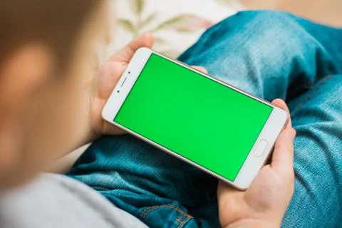 Kid using smartphone during a sunny day at park Foto stock