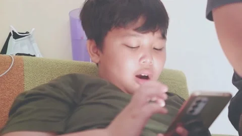 Kid using smartphone. scrolling the phone screen at home Stock Footage 157591425