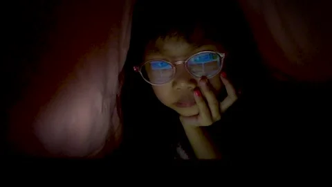 Kid using tablet pc under blanket at night Stock Footage 131874363