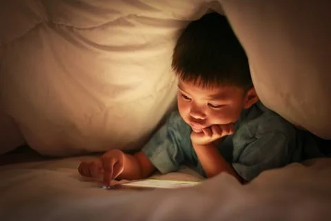 Kid using tablet for watch online cartoon. Stock Photos