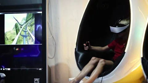 Kid on a virtual reality ride with roller coaster theme. Stock Footage 137675881