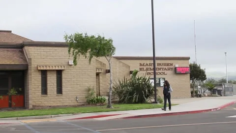 Kid waiting at school alone, pacing in circles Stock Footage 155386408