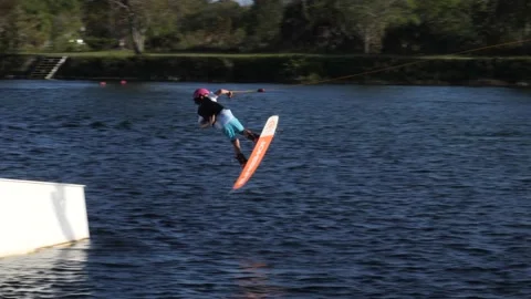 Kid Wakeboarding Spinning Over Ramp Stock Footage 200845321