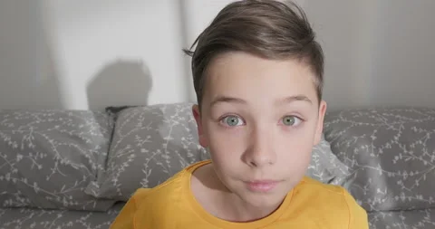 Kid wakes up, late for school. A boy stands up sharply Stock Footage 233285151