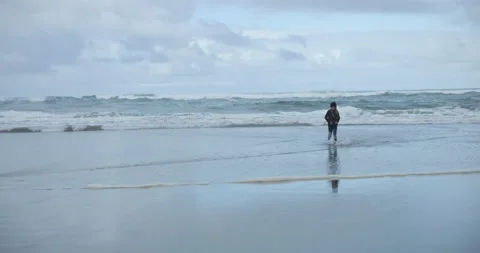 Kid Walking along the Beach With Waves  Stock Footage 201364751