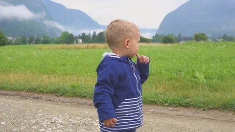 Kid walking and playing alone mountain outdoors. Stockbeeldmateriaal 98378158